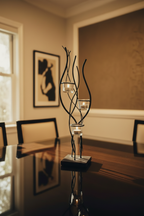 Iron Reverie Candelabra on dark walnut dining table with warm amber candlelight
